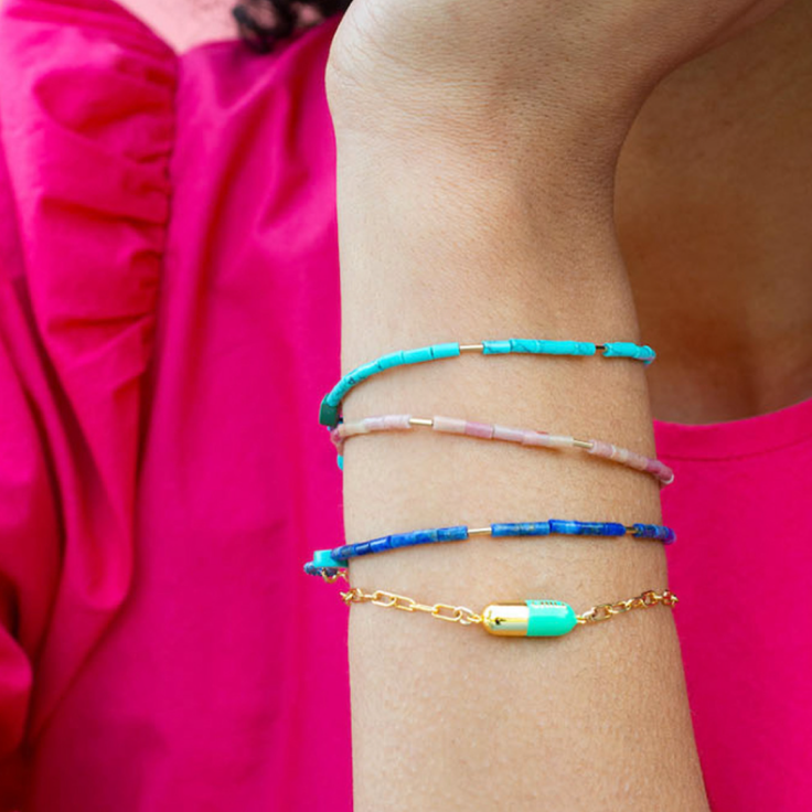 Person wearing bracelets made by ecommerce brand Kris Nations