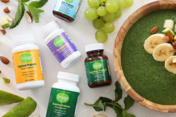 Various health supplements laid out among fruit. 