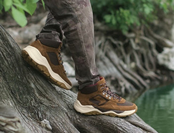 Person walking in nature wearing SAS shoes. 